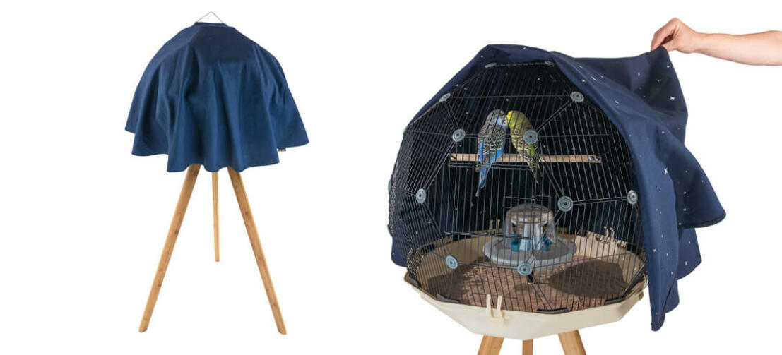 A cover on the geo cage with two budgies