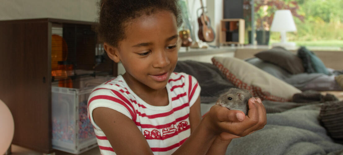A girl holding a hamster