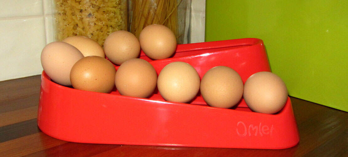 Red egg ramp on a wooden worktop