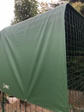 walk in run with a large green heavy duty cover on it