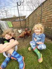 Girls in front of Chickens with Omlet Chicken Fencing