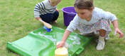 Children cleaning the Eglu Go dropping tray.