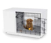 A cavapoo puppy in a Fido Studio wooden dog crate.