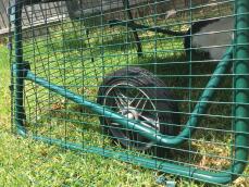 the wheel of a go up chicken coop with a run attached