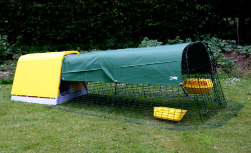 Yellow Eglu Classic chicken coop run with shade cover in garden