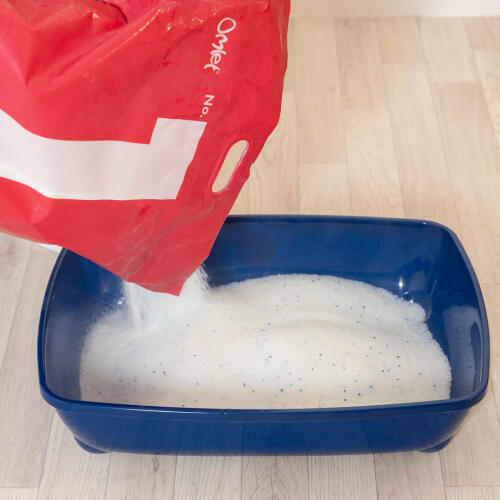 Pouring Omlet Silica Cat Litter into litter tray