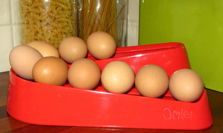Red egg ramp on a wooden worktop