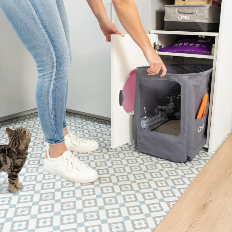 Woman cleaning the Omlet cat litter box