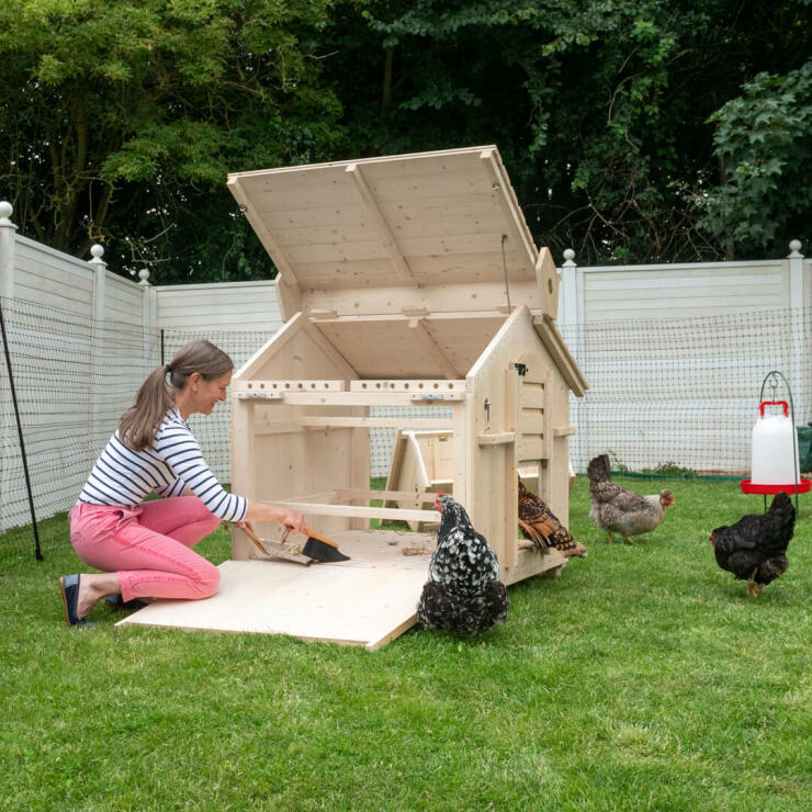 Lady cleaning Lenham Wooden Chicken Coop