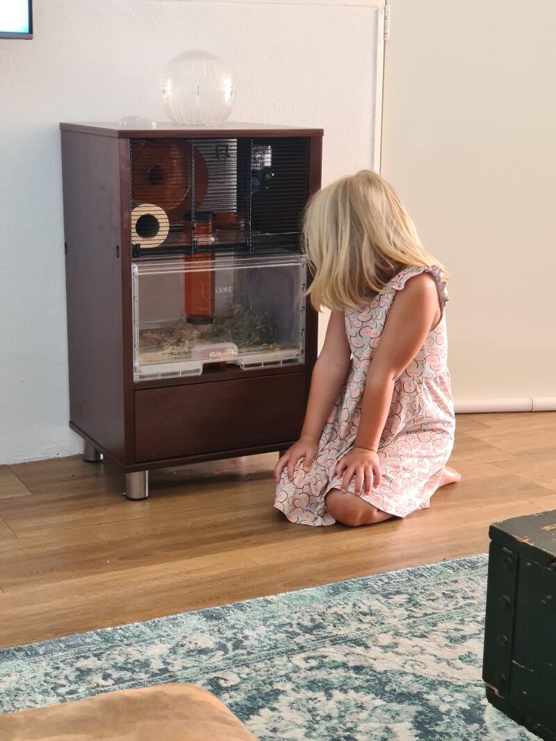 Girl with their Omlet Walnut Qute Hamster Cage