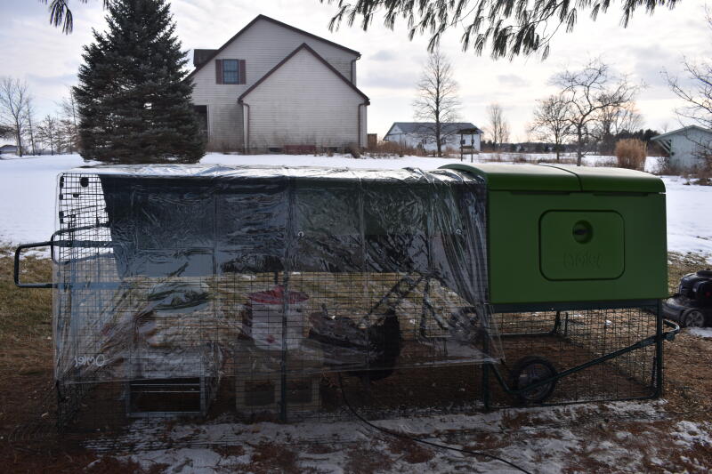 A coop and run covered by an opaque and transparent cover