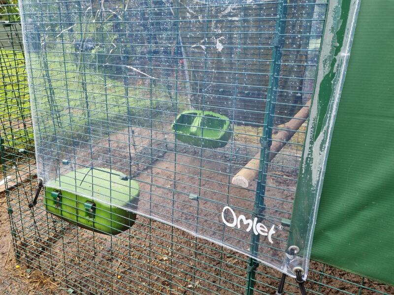 Plastic clear cover protecting the side of a chicken run