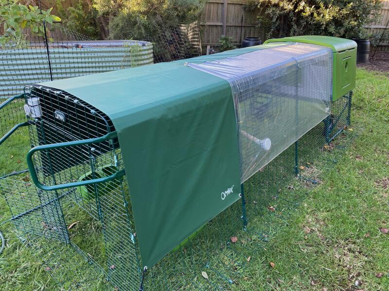 A chicken run covered by opaque and transparent covers