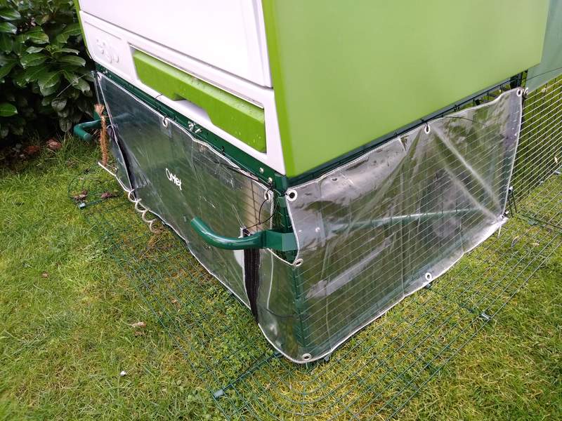 a wind sheild clear cover around the bottom of a cube chicken coop