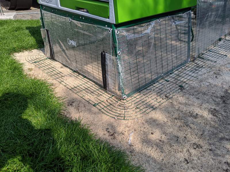 An Eglu Cube chicken coop with clear covers underneath.