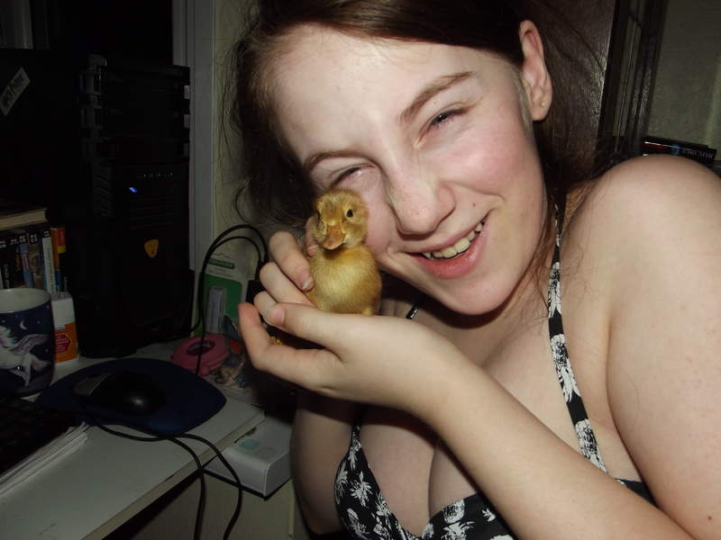 A girl holding a saxony duck.