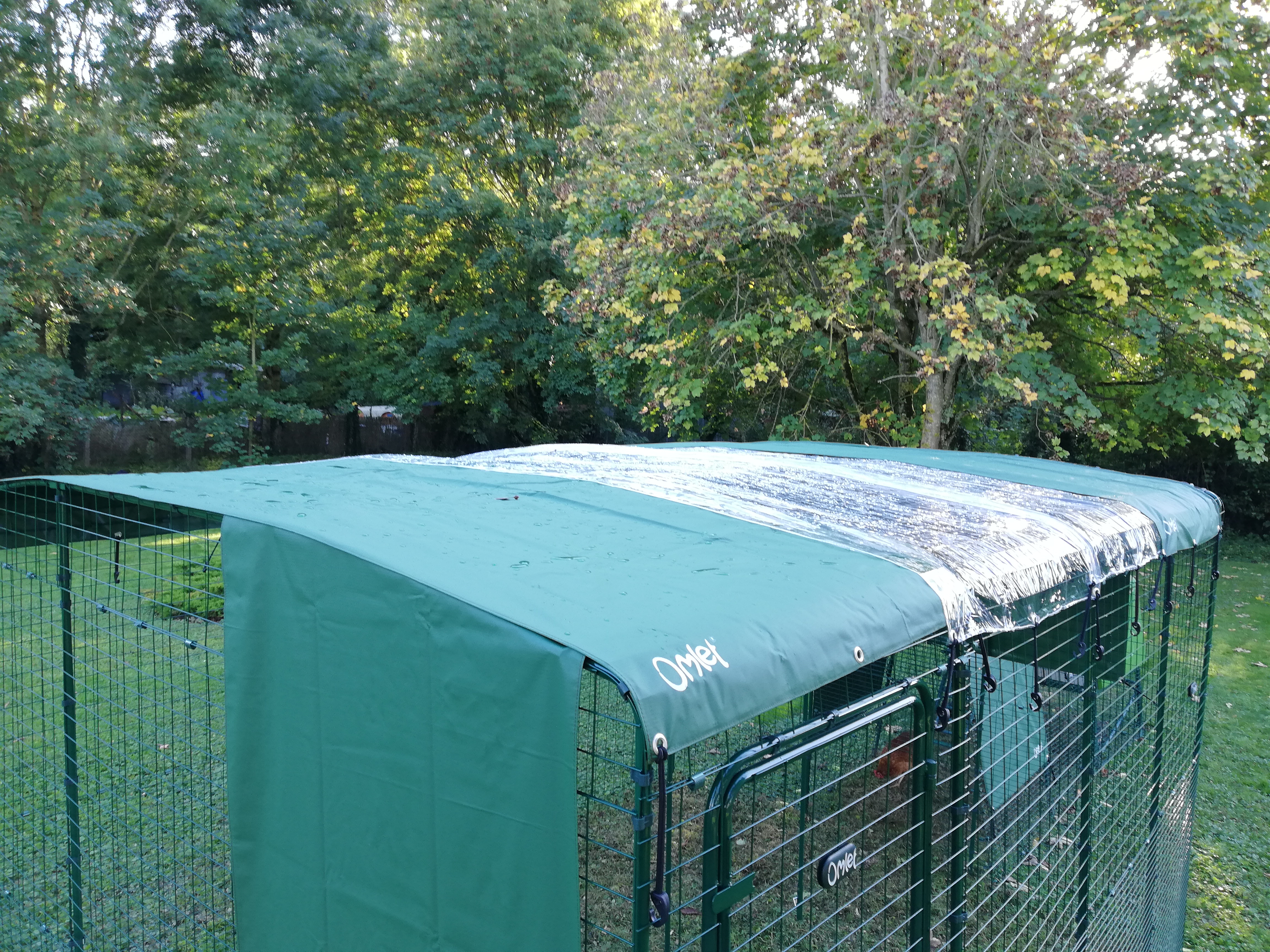 A walk-in chicken run covered by several covers