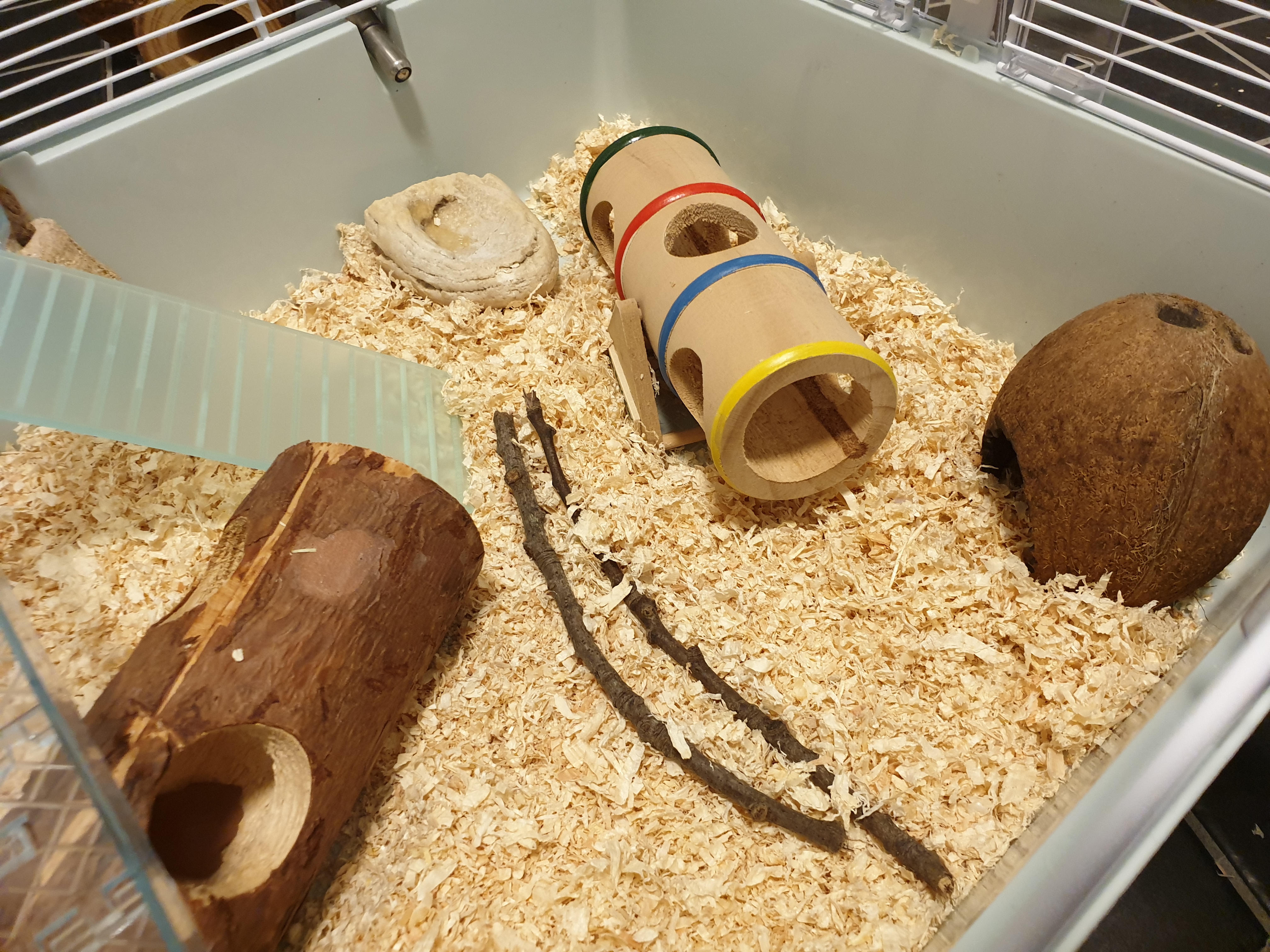 a hamster cage with lots of toys and accessories in it